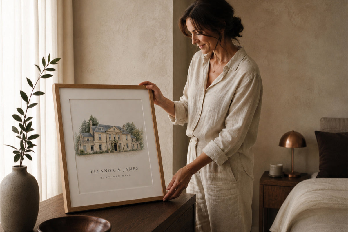 A woman holding a framed personalised portrait of Hawthorn Hall.
