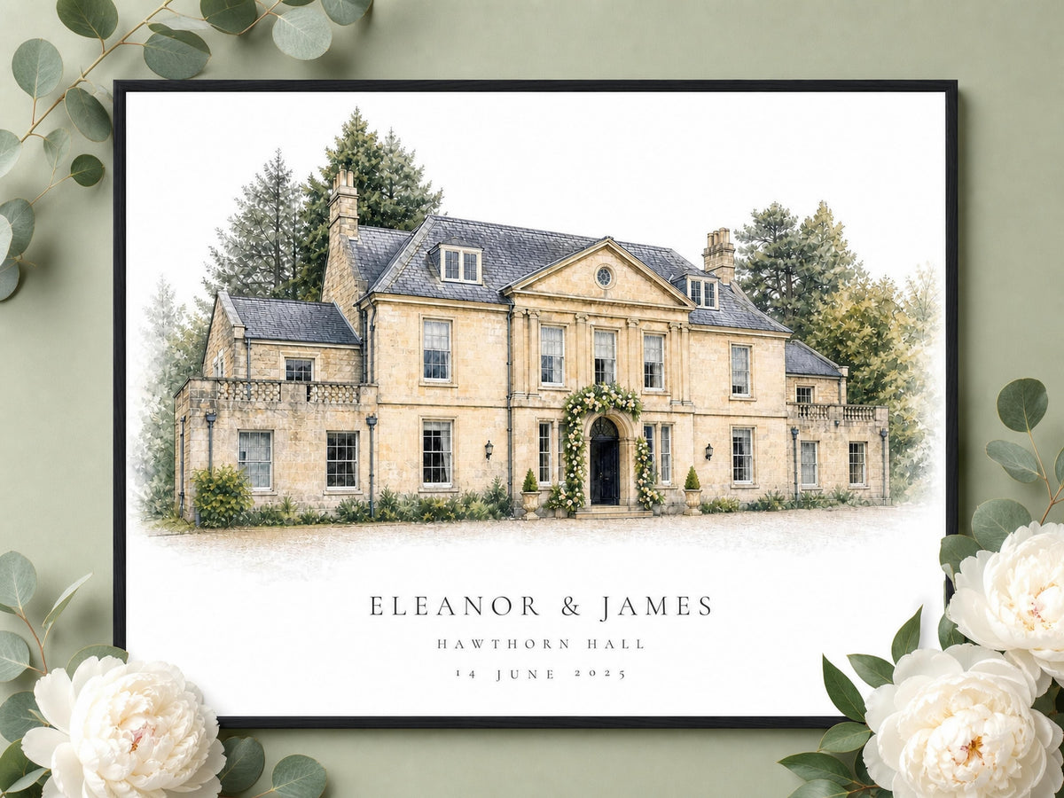 Close view of the venue portrait in a black frame, styled with pale flowers and greenery.